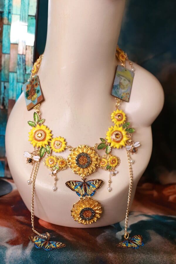 A necklace with sunflowers and butterflies on it.