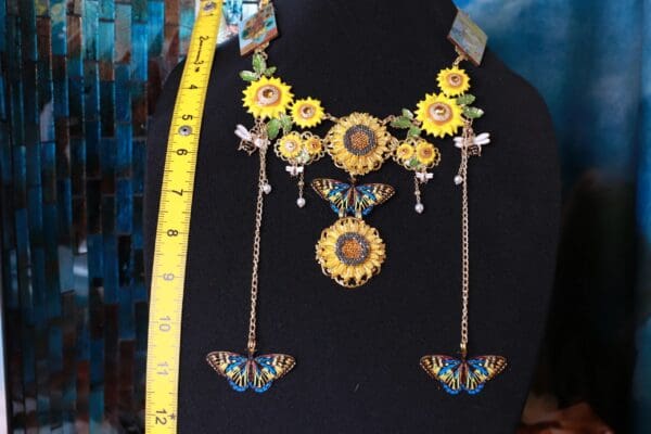 A black shirt with a yellow and blue necklace on it