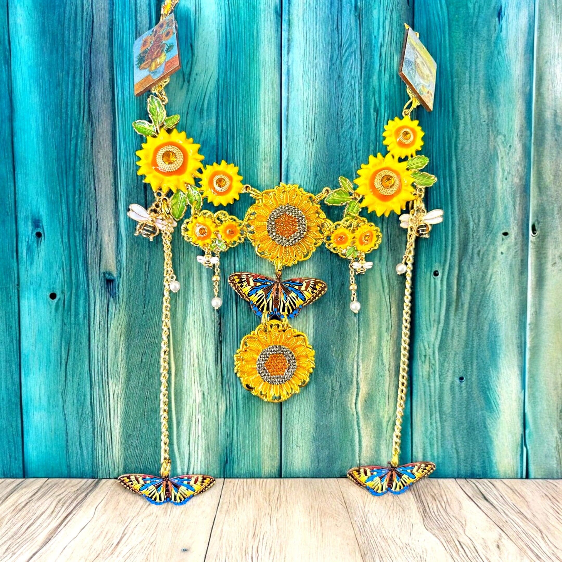 A blue wall with two yellow sunflowers hanging from it.