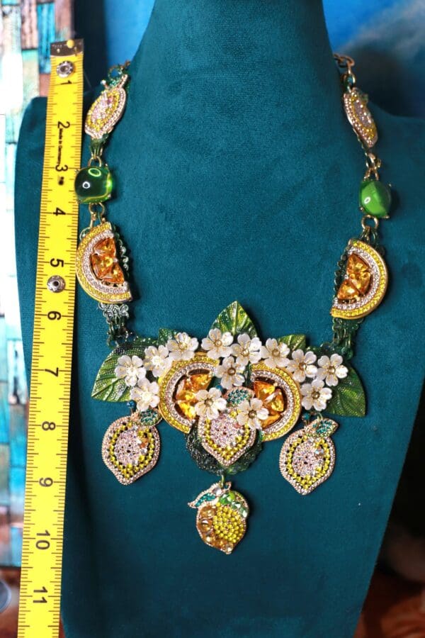 A necklace with lemons and flowers on it