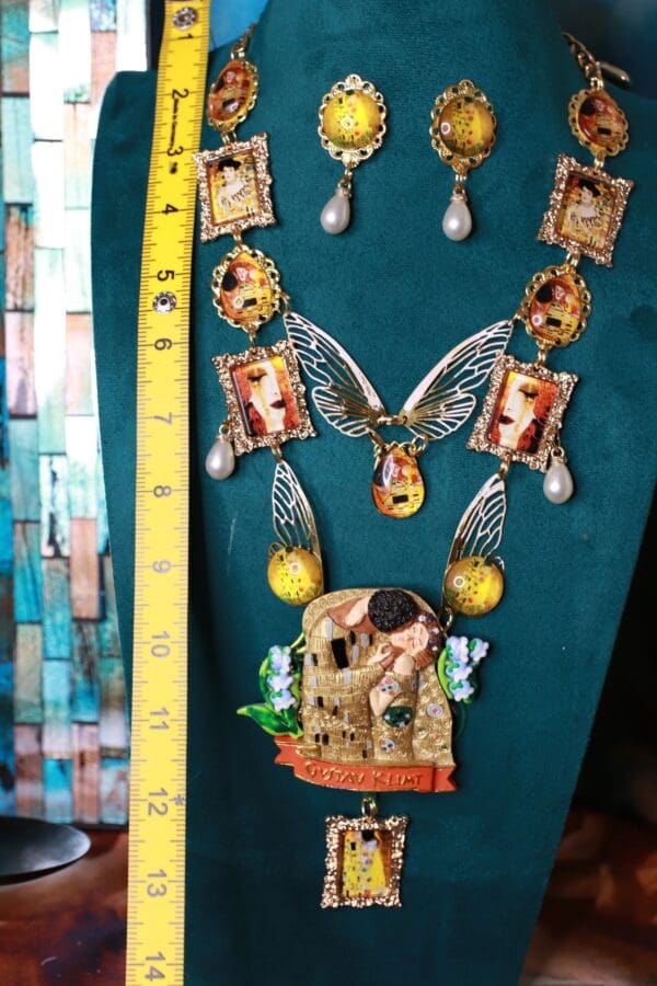A necklace and earrings set with pictures of women.