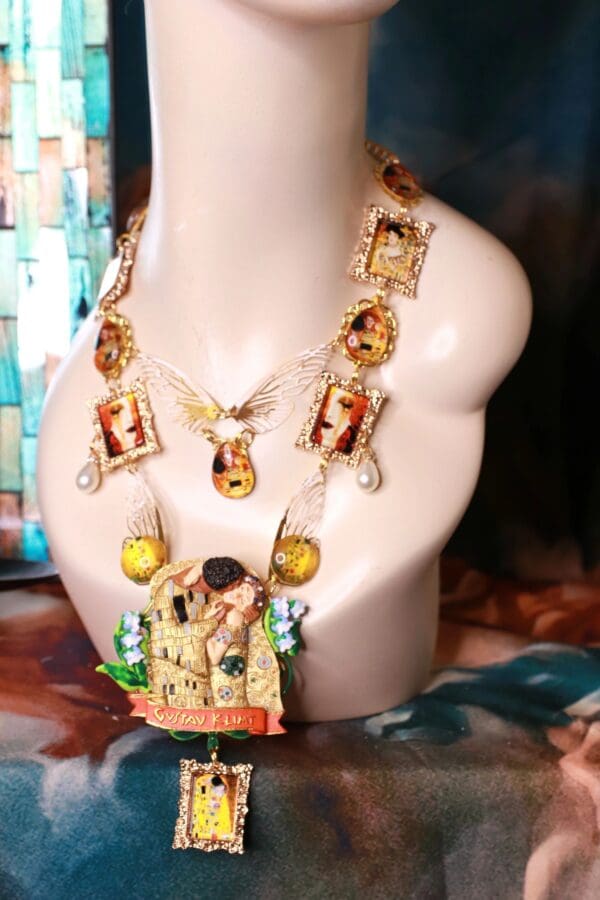 A necklace with pictures of people and a bird.