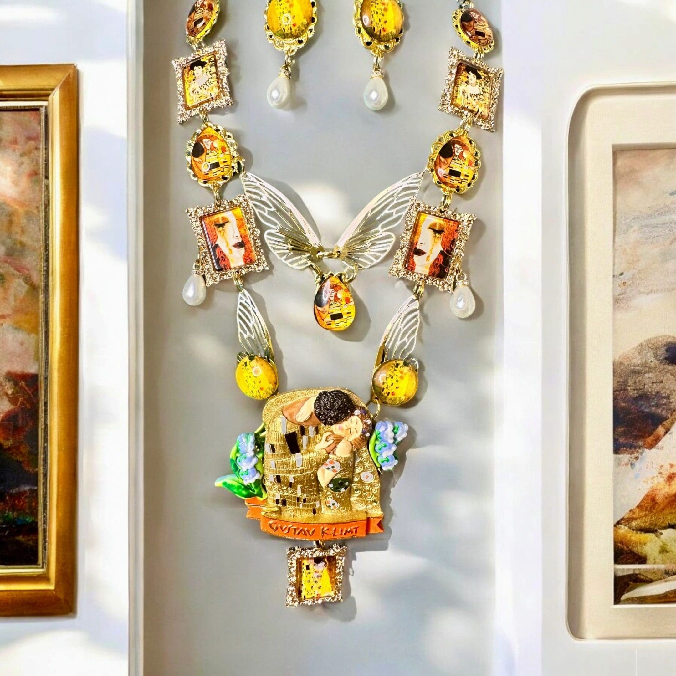 A necklace and earrings hanging on the wall.