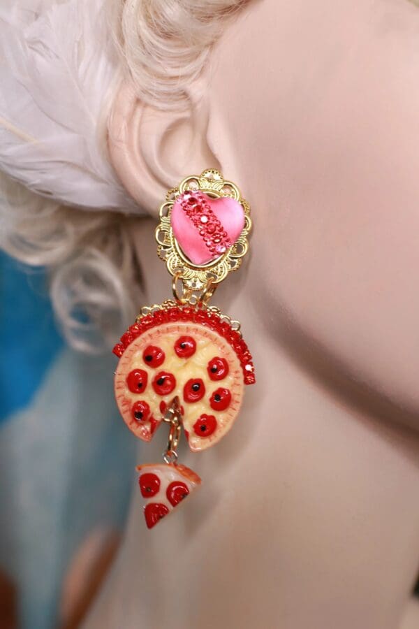 A close up of a person wearing earrings with pizza