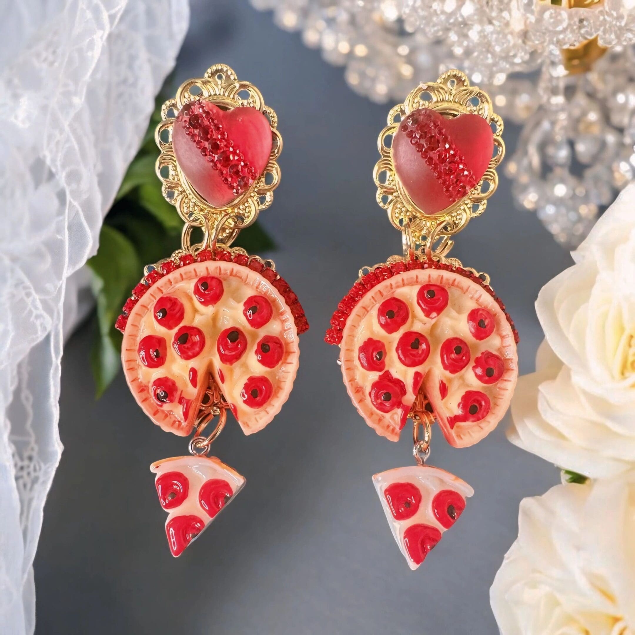 A pair of earrings with pepperoni and cheese pizza slices.