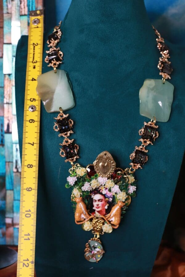 A necklace with a picture of frida kahlo on it.