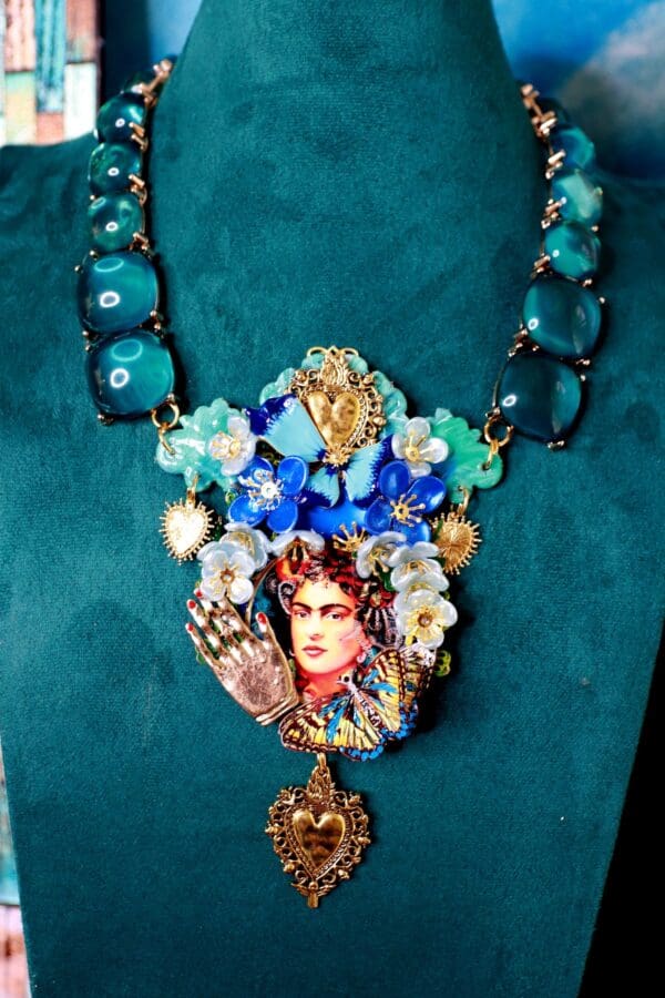 A necklace with a picture of frida kahlo on it.
