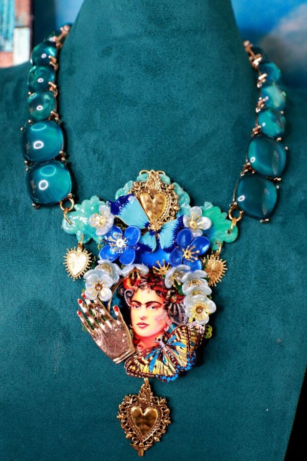 A necklace with a picture of frida kahlo on it.