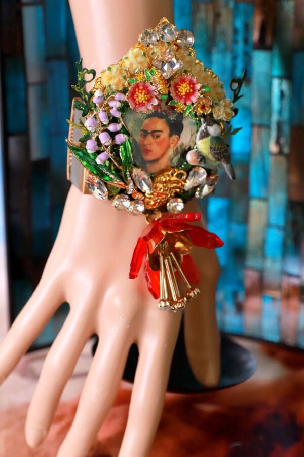 A hand with a necklace of flowers and a picture on it.