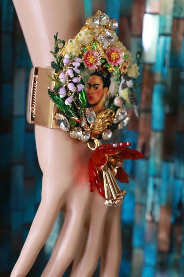 A close up of the arm of a doll wearing jewelry