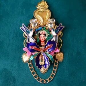 A colorful brooch with a woman and two birds.
