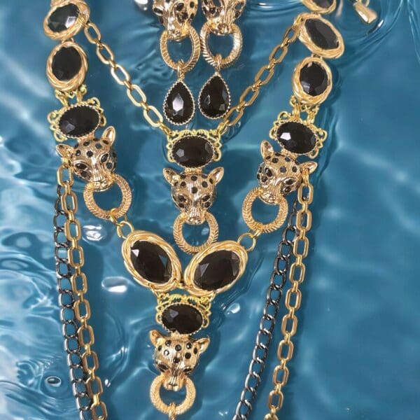 A necklace and earrings set with black stones.