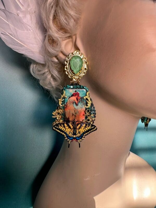 A woman wearing earrings with a bird on it.