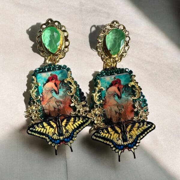 A pair of earrings with a picture on them