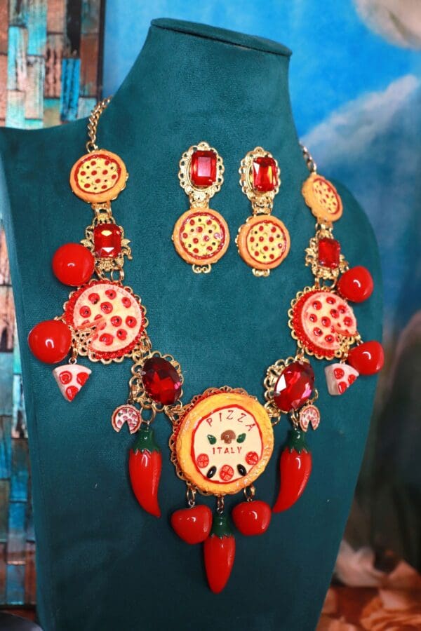 A necklace and earrings set with pepperoni, cheese and tomato toppings.
