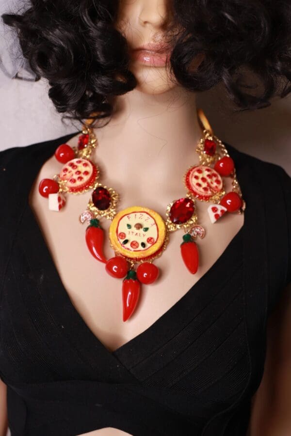 A woman wearing a necklace with red peppers and a clock.