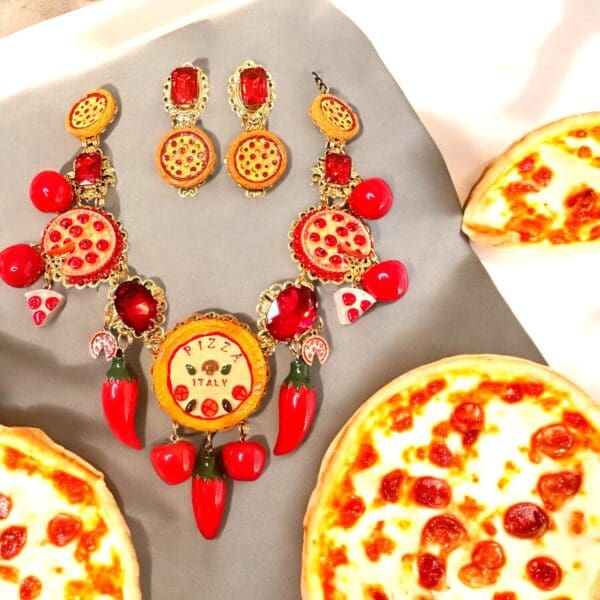 A pizza set with earrings and necklaces on top of the table.