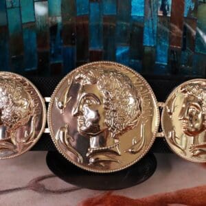 A close up of three gold coins on display