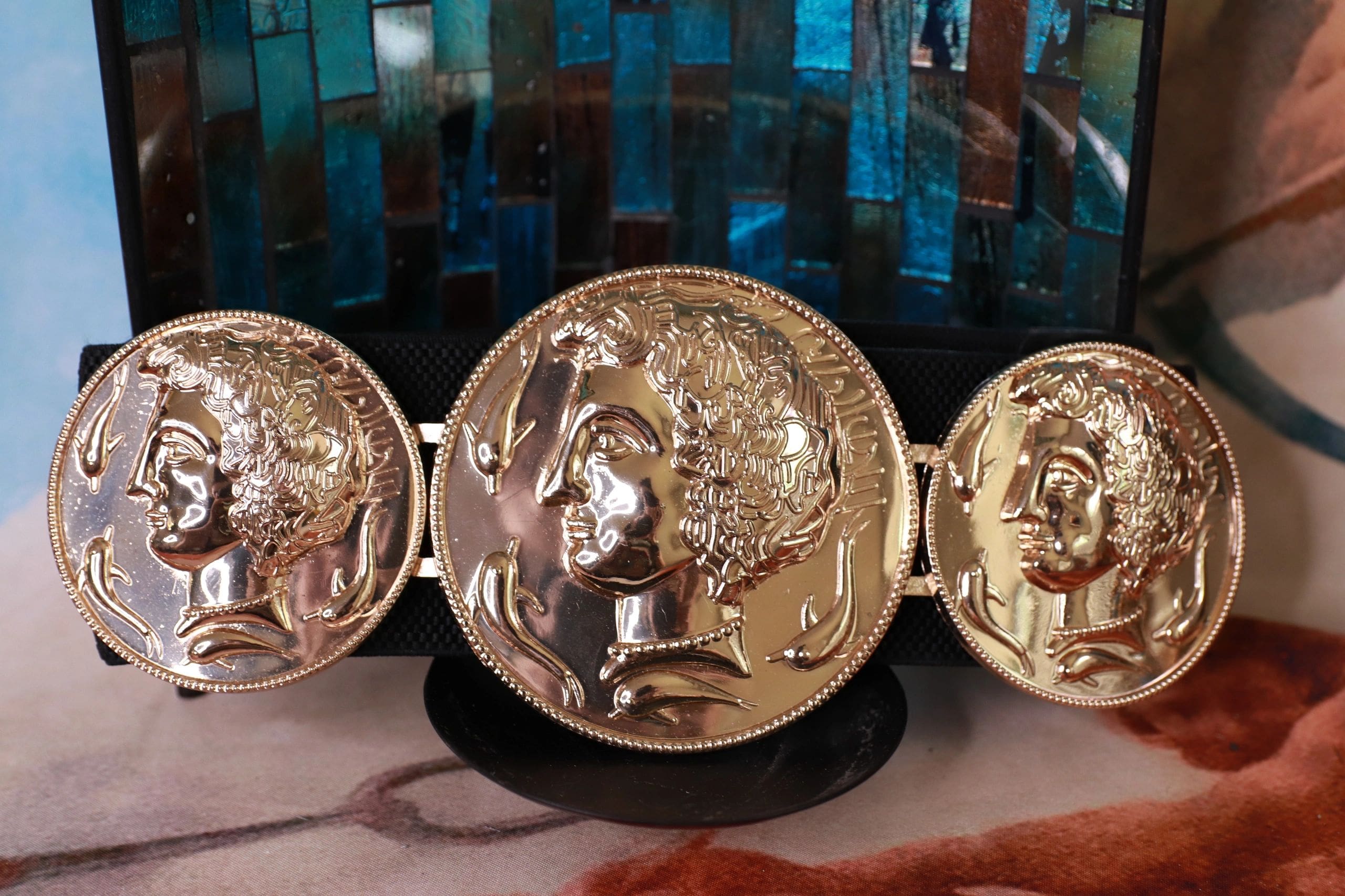 A close up of three gold coins on display