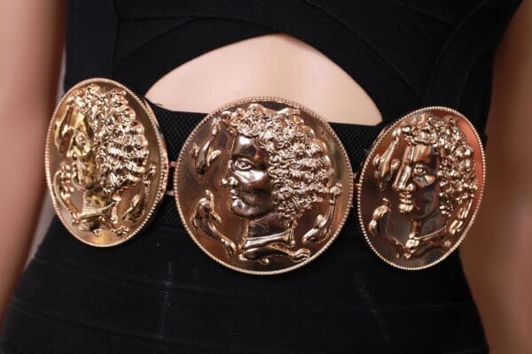 A close up of three coins on a black surface