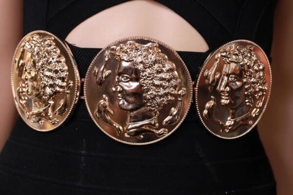 A close up of the three faces on a belt