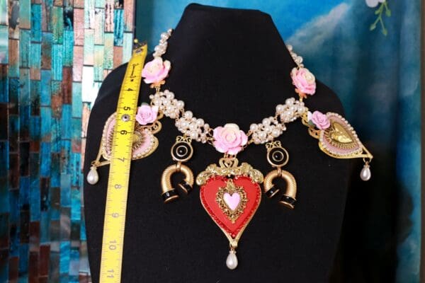 A necklace with hearts and flowers on it