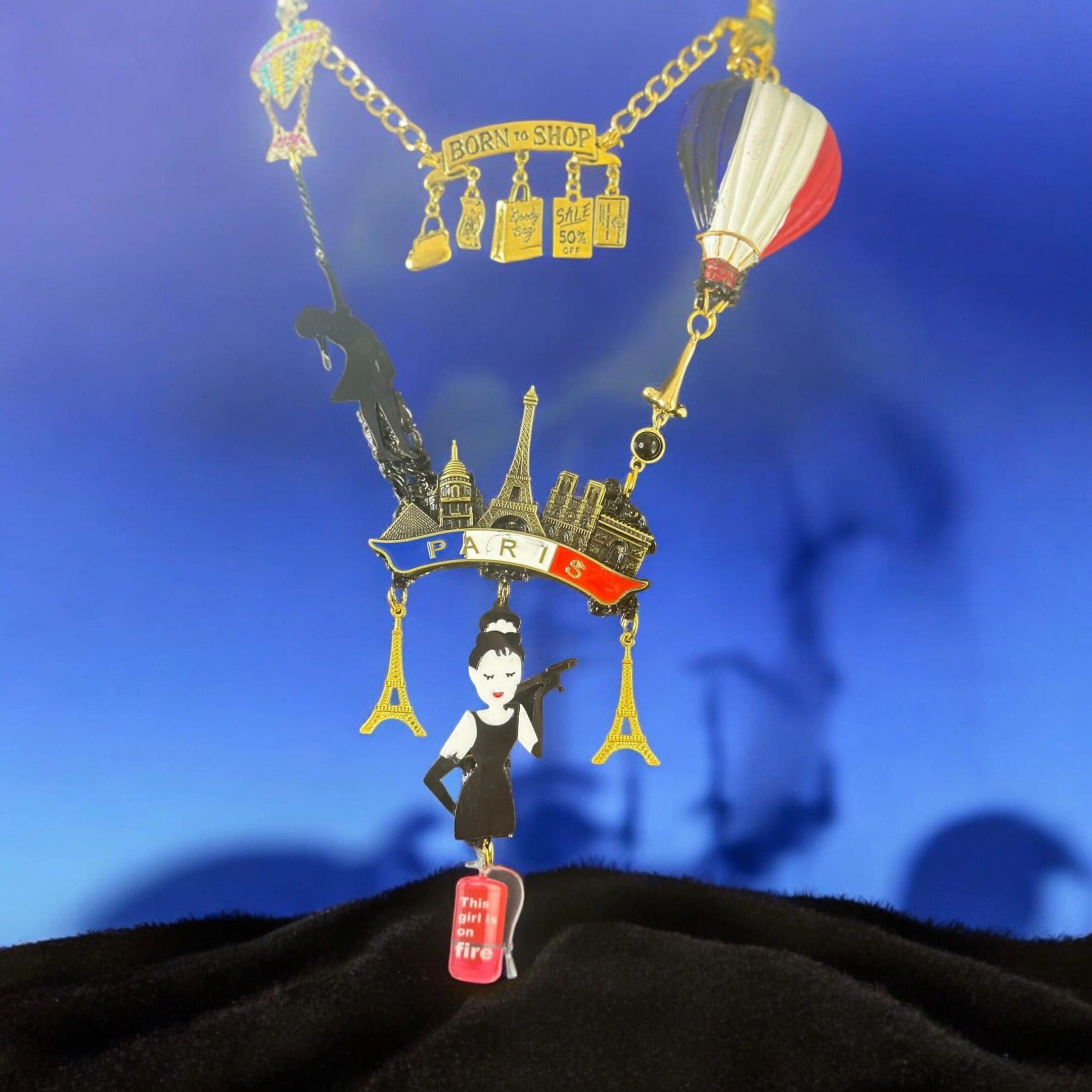 A man standing on top of a hill with a bunch of stuff hanging from it.