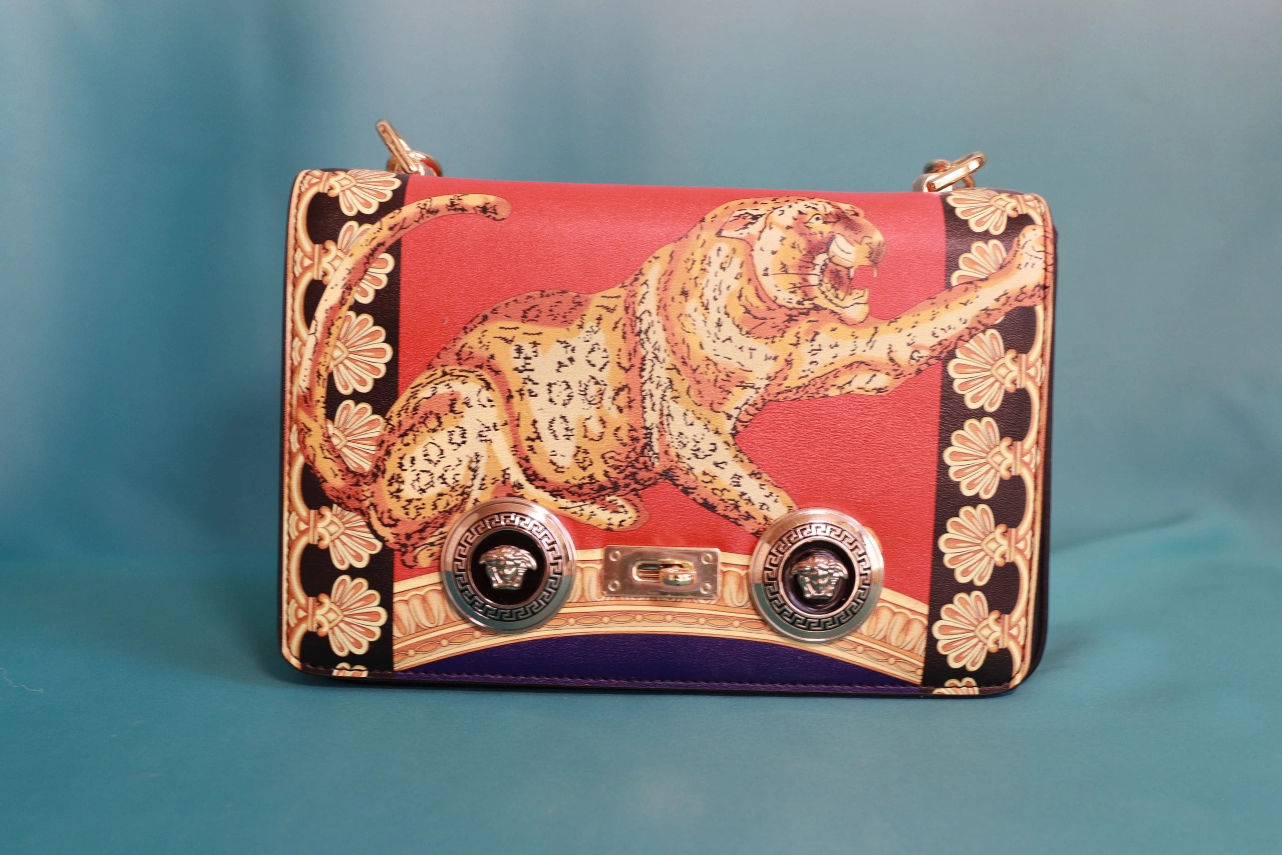 A red purse with an image of a tiger on it.