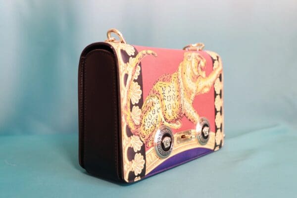 A pink and white purse with a leopard print design.