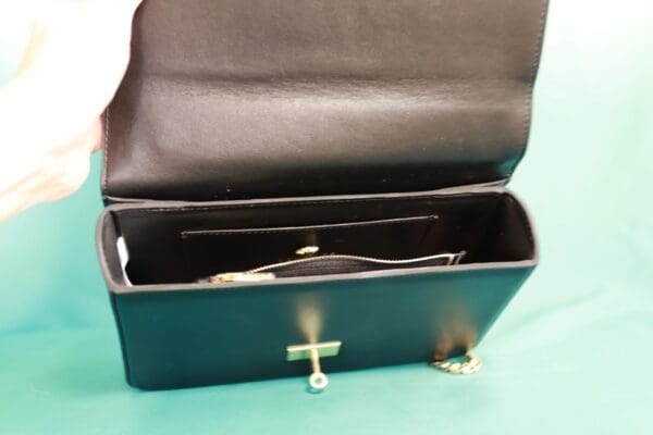 A black leather case with a cross on it.