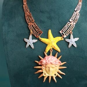 A necklace with a sun and star on it
