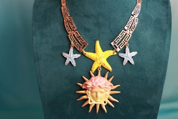 A necklace with a sun and star on it