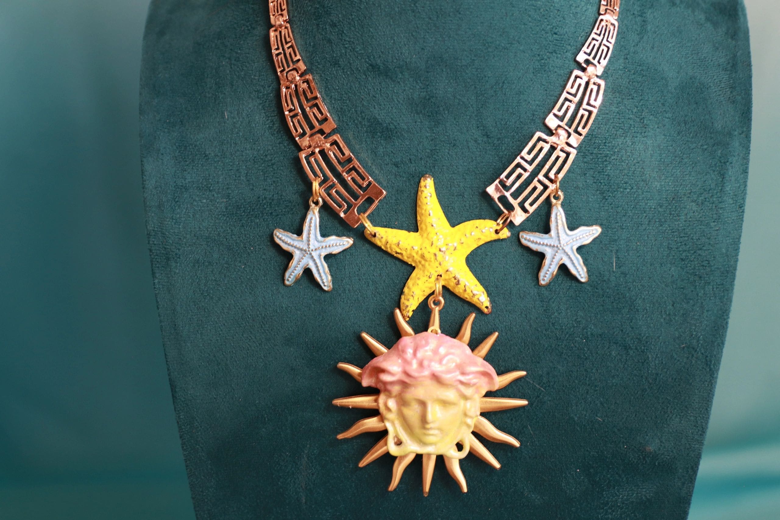 A necklace with a sun and star on it