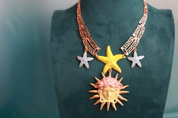 A necklace with a sun and star on it