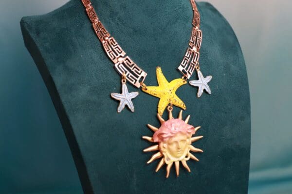 A necklace with a sun and stars on it