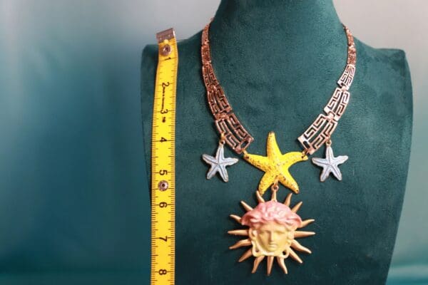 A necklace with a sun and stars on it
