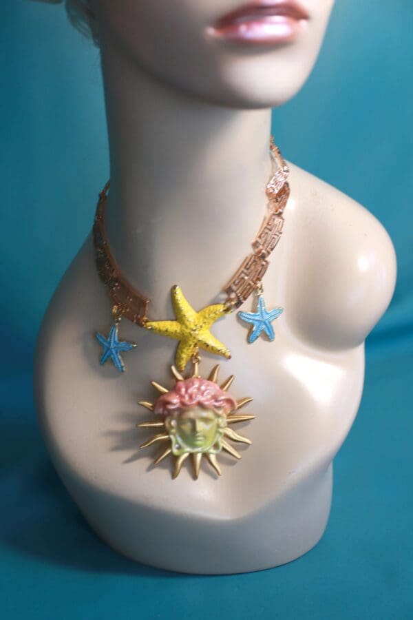 A necklace with a sun and stars on it