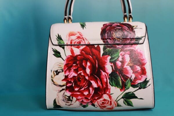 A close up of a purse with flowers on it