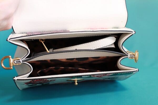 A purse that has two compartments and one is open.