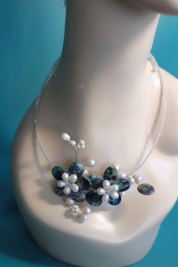 A necklace with flowers and pearls on it