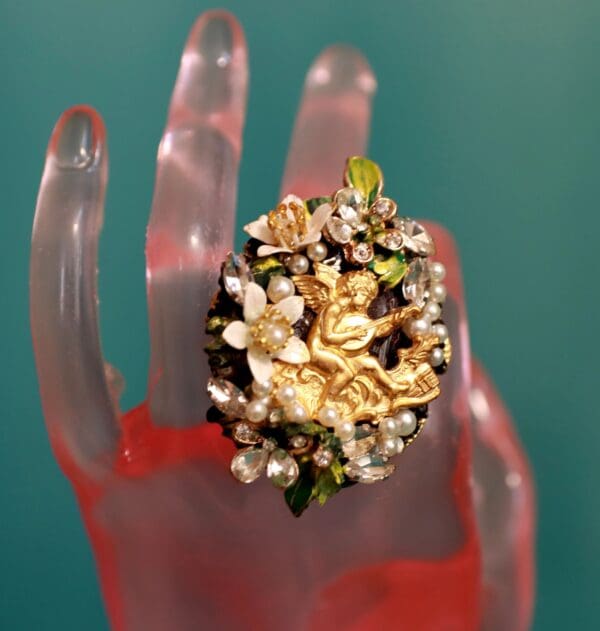 A hand holding a ring with some kind of food on it