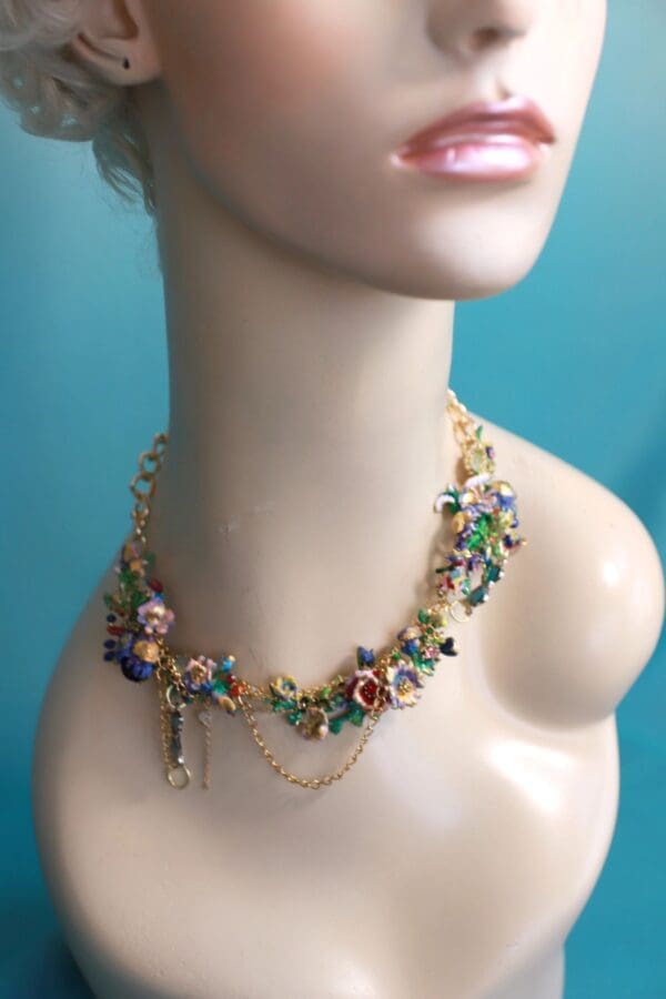 A woman wearing a necklace with colorful flowers.