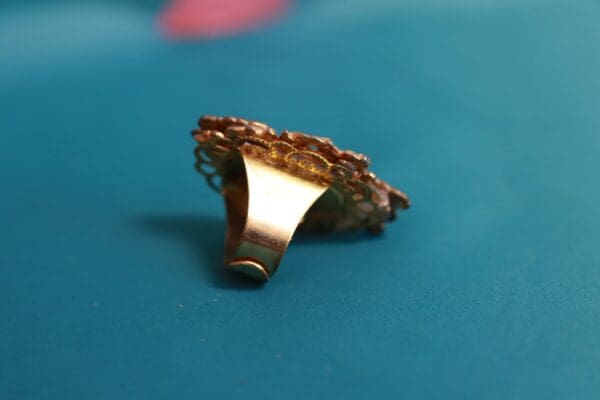 A gold ring sitting on top of a table.