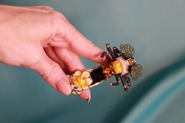 A person holding a bee on top of their finger.