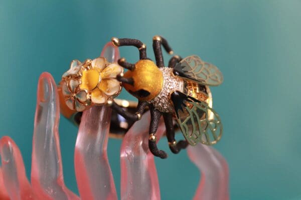 A close up of a ring on top of some pink flowers
