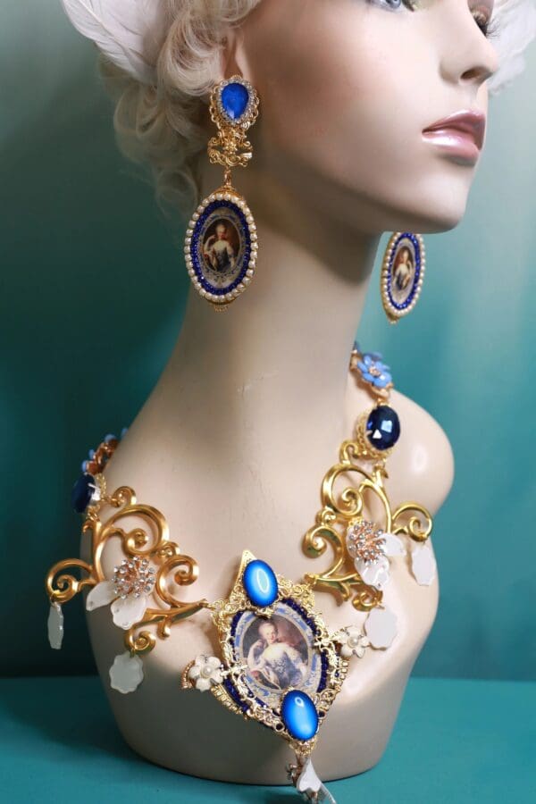 A woman wearing a necklace and earrings with gold