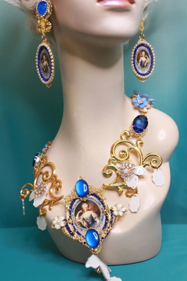 A bust of a woman wearing jewelry and earrings.
