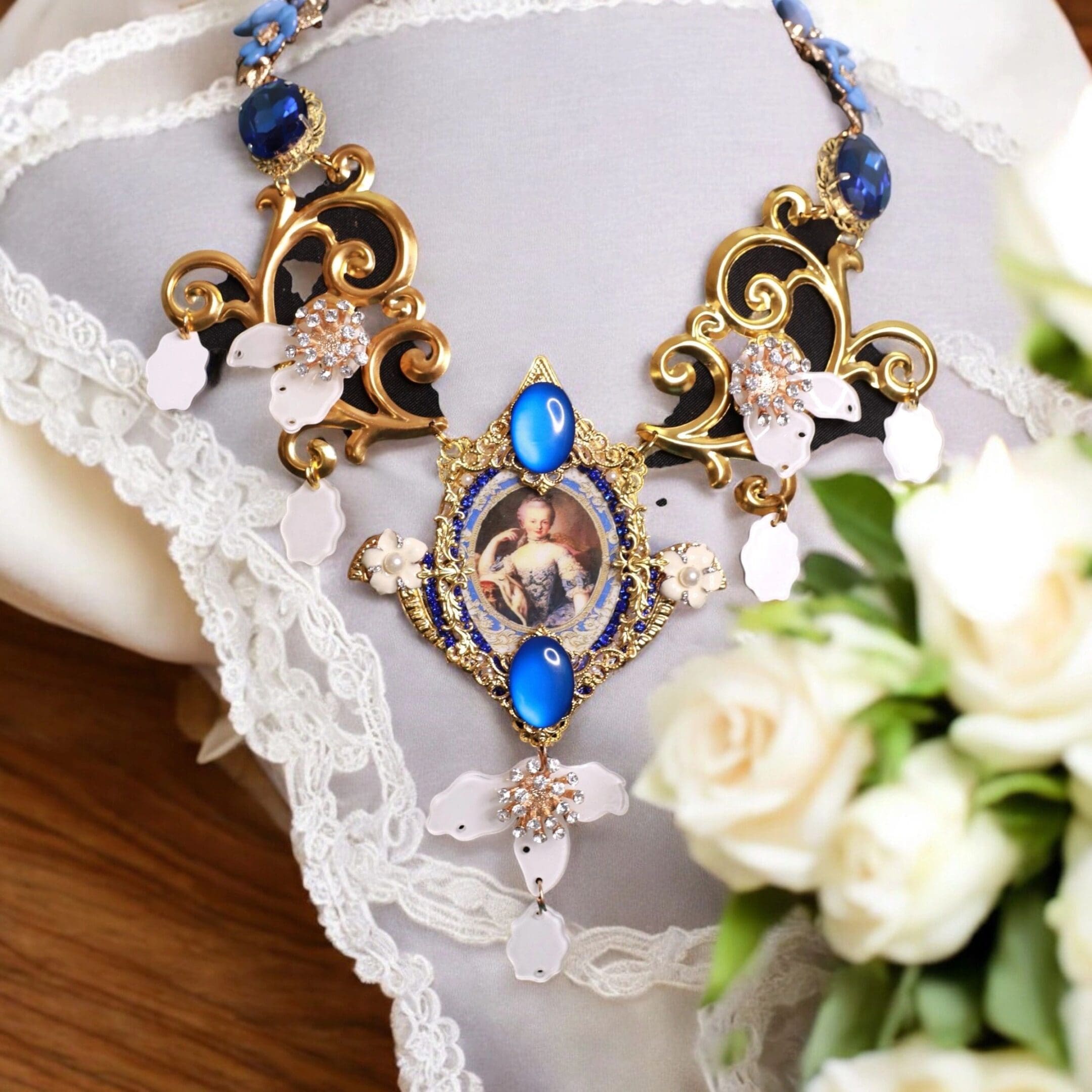 A necklace with blue stones and white flowers.
