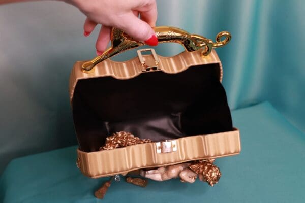 A woman is holding onto the handle of her purse.