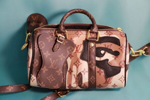 A louis vuitton bag with an egyptian eye design on it.
